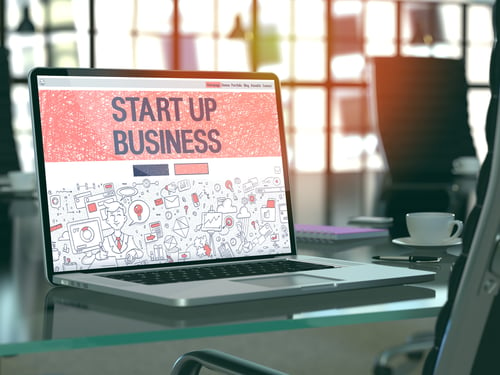 Start Up Business Concept. Closeup Landing Page on Laptop Screen in Doodle Design Style. On Background of Comfortable Working Place in Modern Office. Blurred, Toned Image. 3D Render.